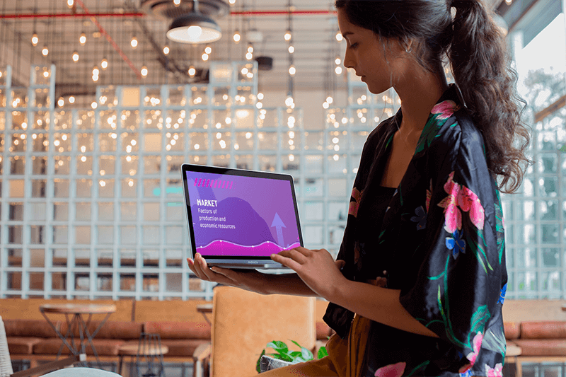 Woman Using A Macbook Mockup While Standing At A Startup A21169