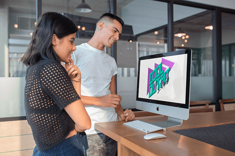 Man And Woman Looking At An Imac Mockup In A Modern Office